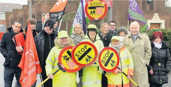  ??  ?? &gt; Lollipop attendants and supporters during a protest against the council’s proposed cuts outside St Margaret Mary RC School in Perry Common Road