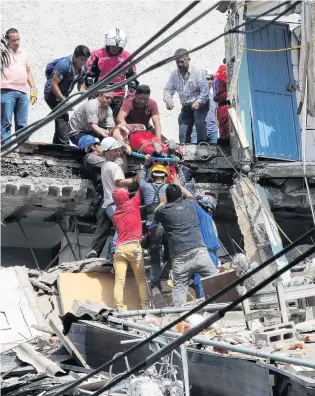  ?? PHOTO: REUTERS ?? Devastatio­n . . . Rescue workers help a person out of the rubble of a collapsed building after an earthquake hit Mexico City, Mexico.