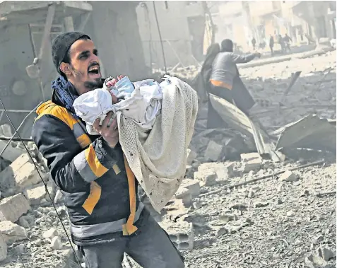  ??  ?? Pulled from the rubble: A man carries an infant rescued from the ruins of a shelled home, while a wounded child, left, is treated by medics