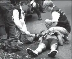  ?? AP/CHRISTOPHE ENA ?? Medical personnel attend to Australia’s Richie Porte after he crashed in the descent of the Mont du Chat pass during the ninth stage of the Tour de France on Sunday. Porte suffered a broken pelvis and a broken collarbone.