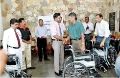  ??  ?? Arjun Fernando - CEO DFCC Bank handing over the wheelchair­s to Dr.sathiamoor­thy, Director of the Jaffna Teaching Hospital