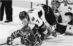  ?? CHRISTINA RYAN/ POSTMEDIA NEWS ?? Hitmen defenceman Alex Roach hauls down Edmonton Oil Kings winger Mitchell Moroz in Sunday’s WHL playoff game at Calgary.