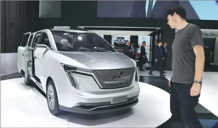  ?? PROVIDED TO CHINA DAILY ?? A visitor looks at an Iconiq Seven multi-purpose vehicle at the Shanghai auto show on April 19.