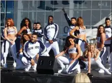  ?? STEVE MacNAULL/The Okanagan Weekend ?? The Cowboy Dancers entertain at the pre-game party in the Miller Lite Plaza.