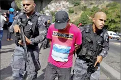  ??  ?? Riot police detain a suspect during an operation after violent clashes between drug gangs in Rocinha slum in Rio de Janeiro, Brazil. — Reuters photo