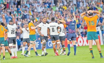  ?? Picture: MARTIN SERAS LIMA ?? FIJI Water Flying Fijians players celebrate their win against the Wallabies during the second pool match of the Rugby World Cup.