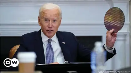  ??  ?? 'This is infrastruc­ture,' Biden told the CEOs, holding up a silicon wafer, a core component in making computer chips, imported in large part from Asia at present