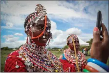 ?? ?? A Maasai woman takes a selfie Dec. 10 as she prepares to watch the Maasai
Olympics.