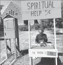  ?? Canadian Press handout/Mark Kleiner ?? Pastor Mark Kleiner is shown sitting at a roadside stand in Saskatoon in this undated handout photo. A Saskatoon pastor is taking a page out of Charles Schultz’s classic “Peanuts” comic strip by offering spiritual advice and a glass of fruit punch at a...