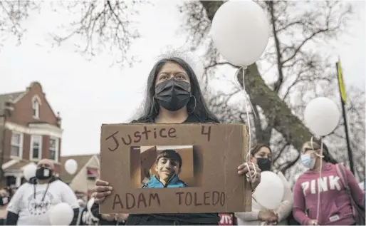  ?? ASHLEE REZIN GARCIA/SUN-TIMES ?? Ana Solano, 26, of Little Village, joins dozens Monday afternoon at a vigil for 13-year-old Adam Toledo near the location of the shooting at West 24th Street and South Sawyer Avenue in Little Village.