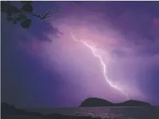  ?? Picture: ROSS PALM ?? STORMY: Lightning at Double Island off Palm Cove.
A PALM Cove resident captured this incredible bolt of lightning off the northern beaches.
Ross Palm woke to the crack of thunder and a storm raging off the coast at Double Island at 4.30am.
“I got in the car and raced down to the Esplanade and just started snapping away,” he said. “It was taken on a Samsung phone – I haven’t even got a camera but it turned out incredible.”
Mr Palm, who has lived in the area 25 years, said it came as a surprise after a bright and sunny Christmas Day and a dry year for the region.