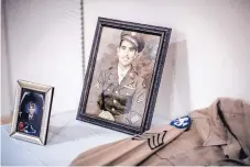  ??  ?? A photo of young Joe Romero, taken after his liberation from a Japanese POW camp, is displayed at a medal presentati­on ceremony for Romero on Saturday at the Veterans’ Memorial Visitor Center in Southeast Albuquerqu­e.