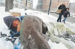  ?? Craig F. Walker, ?? Ron Veenstra rests under a tarp after spending the night with Occupy Denver demonstrat­ors at Civic Center in 2011 in Denver.