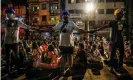  ?? Photograph: AFP/Getty Images ?? Protesters hold hands to keep watch during a night-time demonstrat­ion against the military coup in Yangon