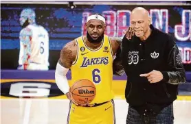  ?? Marcio Jose Sanchez/Associated Press ?? Lakers forward LeBron James poses with former Lakers center Kareem Abdul-Jabbar after James passed him to become the NBA’s scoring leader.