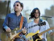  ??  ?? TAYLOR GOLDSMITH, left, and Wylie Gelber of American folk rock band Dawes perform Saturday.