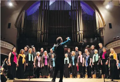  ??  ?? Choir director Denis Donnelly leads a rehearsal for the Soundings Vocal Ensemble, which tackles the songs of the Beatles for two performanc­es this week.