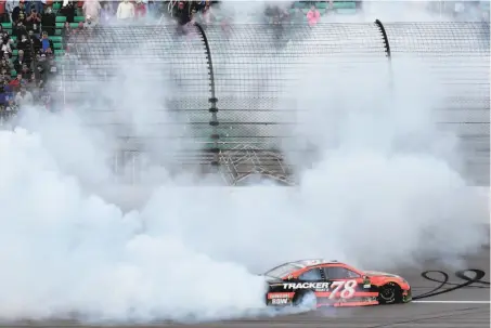  ?? Ed Zurga / Associated Press ?? Martin Truex Jr. does a burnout after winning a NASCAR Cup Series auto race at Kansas Speedway on Sunday.