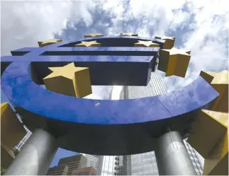  ??  ?? A huge euro logo is pictured next to the headquarte­rs of the European Central Bank (ECB). (Reuters)