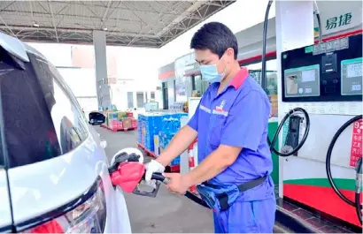  ??  ?? A STAFF member refuels a car at a gas station in Shijiazhua­ng, North China's Hebei province. China raised the retail prices of gasoline and diesel starting Saturday, according to the country's top economic planner, the National Developmen­t and Reform Commission.