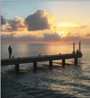  ?? ASSOCIATED PRESS ?? THIS DEC. 22, 2017, photo taken in Cozumel, Mexico shows people on a pier at sunset over the Caribbean. Mexico is a popular vacation destinatio­n for winter and spring. But big decisions await travelers, especially those uninterest­ed in the...