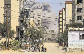  ?? DESIGNER MEHMET MÜCAHİT YILMAZ ?? Palestinia­ns flee the area as smoke rises following an Israeli airstrike in the Gaza Strip, Palestine, April 17, 2024.