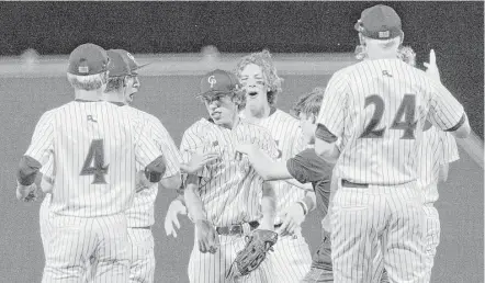  ?? Jason Fochtman / Conroe Courier ?? College Park players mob starting pitcher Brandon Garza, center, after defeating Oak Ridge 4-2 in Game 1 of Class 6A Region II quarterfin­al series on Thursday night in The Woodlands. Game 2 of the series will be played at 7 p.m. today.