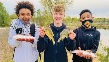  ??  ?? Bentonvill­e anglers show off their catches in this file photo. (Special to The Commercial/Arkansas Game and Fish Commission)