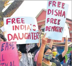  ??  ?? Protesters hold placards during a demonstrat­ion against the arrest of climate activist Disha Ravi, in Bengaluru on Monday.