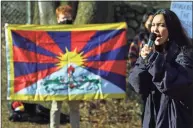  ?? Christian Abraham / Hearst Connecticu­t Media ?? Tibetan activist Tsela Zoksang leads a protest at the gate leading to NBC’s campus on Blachley Road in Stamford, on Saturday. Around 20 people gathered to protest China’s human rights violations, NBC and its involvemen­t in covering the 2022 Winter Olympics in Beijing.