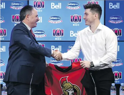  ?? JUSTIN TANG/THE CANADIAN PRESS ?? General manager Pierre Dorion and the newest Ottawa Senator, centre Matt Duchene, hold his new jersey after a news conference in Ottawa on Monday. The Senators can win the trade if they are able to re-sign him to a long-term contract, Don Brennan writes.