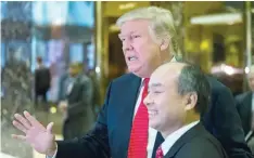  ?? — AFP ?? President-elect Donald Trump talks to the media with SoftBank Group Corp founder and CEO Masayoshi Son in the lobby of Trump Tower in New York.