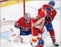  ?? CANADIAN PRESS PHOTO ?? Montreal Canadiens goaltender Jake Allen (34) is scored on as Calgary Flames’ Elias Lindholm (28) and Montreal Canadiens’ Jeff Petry (26) look on during second period NHL hockey action Wednesday in Montreal.