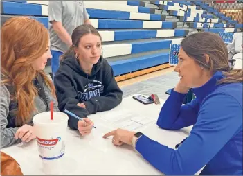  ?? Adam Carey ?? Armuchee High School student Ivey Whitaker and her mother, Jennifer Whitaker, review plans with business teacher Michelle Arp during Thursday’s Bridge Day at AHS.