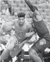  ?? LUIS M. ALVAREZ/AP ?? Florida State’s M.J. Walker (23) moves the ball around Oklahoma State’s Cameron McGriff on Saturday.