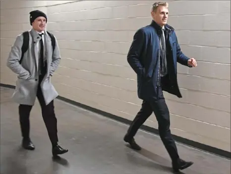  ??  ?? Arriving just before game time and living out a waking nightmare, newly acquired Penguins forwards Nick Bjugstad and Jared McCann hurry to the locker room at PPG Paints Arena to prepare for a game Friday against the Ottawa Senators.