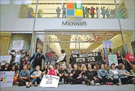  ?? Johannes Eisele AFP/Getty Images ?? PROTESTERS block the entrance of a Microsoft store in Manhattan during a September rally. Microsoft is the parent of GitHub.