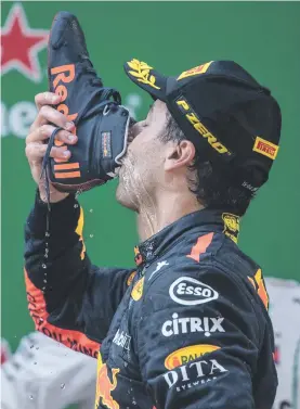  ?? Picture: AFP ?? HE’S GOT SOLE. Red Bull’s Australian driver Daniel Ricciardo drinks champagne out of his shoe as he celebrate after winning the Chinese Grand Prix in Shanghai yesterday.
