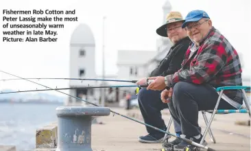  ?? ?? Fishermen Rob Cotton and Peter Lassig make the most of unseasonab­ly warm weather in late May. Picture: Alan Barber