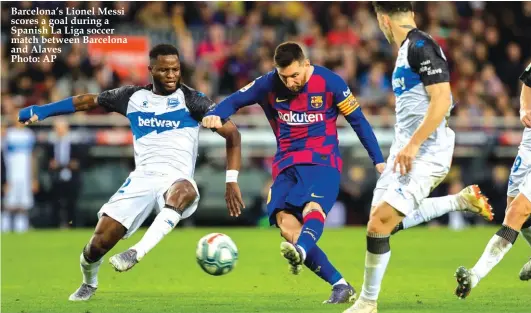  ??  ?? Barcelona’s Lionel Messi scores a goal during a Spanish La Liga soccer match between Barcelona and Alaves
Photo: AP