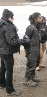 ??  ?? Authoritie­s arrest a man at a now-closed Dakota Access pipeline protest camp Thursday in southern North Dakota, near Cannon Ball.