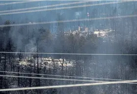  ?? Timothy Hurst, Daily Camera ?? The charred foundation­s of homes after the CalWood fire can be seen on the west side of U. S. 36, just north of Nelson Road on Sunday.