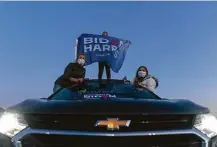  ?? Carolyn Kaster / Associated Press ?? Supporters watch from their car as Democratic presidenti­al candidate Joe Biden speaks Friday in Novi, Mich.