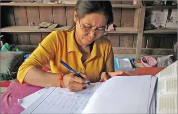  ?? PHOTO SUPPLIED ?? A woman records fish data in a logbook as part of the WISH-Ponds aquacultur­e project in Stung Treng province in 2012.