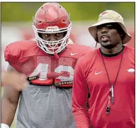  ?? NWA Democrat-Gazette/ANDY SHUPE ?? Sophomore Jonathan Marshall (left) is one of several players who has moved from end to tackle this season under John Scott (right), Arkansas’ defensive line coach.