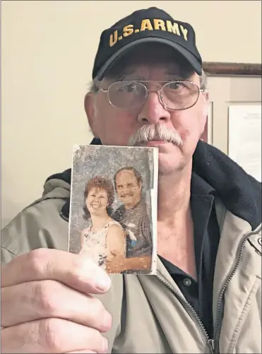  ?? [DORAL CHENOWETH III/DISPATCH] ?? David Austin shows the wallet-sized photograph of his late wife, Bonnie, that he keeps in his wallet. Bonnie is one of 27 people that Mount Carmel Medical Center says were given a lethal dose of pain medication by a doctor who has since been fired.