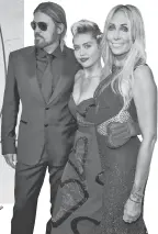  ?? MARK HUMPHREY, AP NEILSON BARNARD, GETTY IMAGES ?? Cyrus, with his famous daughter, Miley, and his wife, Tish Cyrus, arrives for a benefit gala last summer in New York.