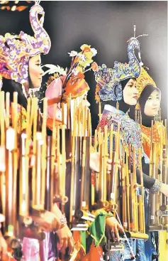  ??  ?? Members of the Ngangklung Ceria AABB group from Indonesia playing the traditiona­l angklung musical instrument.