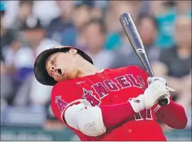  ?? Elaine Thompson Associated Press ?? THE BIG SEASON of Shohei Ohtani, backing away from an inside pitch against Seattle, has helped the Angels stay around .500 despite injuries to other stars.