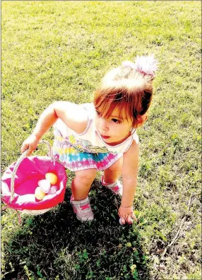  ?? RACHEL DICKERSON/MCDONALD COUNTY PRESS ?? Alana Jones stoops to pick up an egg during the Noel Easter egg hunt, sponsored by the Noel Fire Department on Saturday.